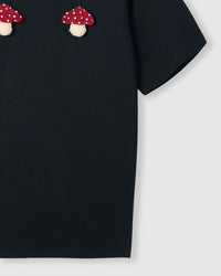 Side view of Mushroom T-Shirt in black showing sleeve and hem