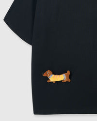 Detail of plush dachshund on body of STICKYZOO black Dachshund Parade T-Shirt showing hand-stitched 3D detail