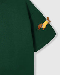 Detail of plush dachshund on body of STICKYZOO forest green Dachshund Parade T-Shirt showing hand-stitched 3D detail