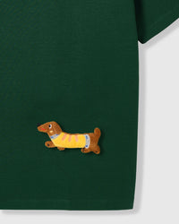 Detail of plush dachshunds on body and sleeve of STICKYZOO forest green Dachshund Parade T-Shirt