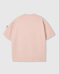 Back view of STICKYZOO pink Dachshund Parade T-Shirt showing boxy silhouette and dachshund peeking at sleeve
