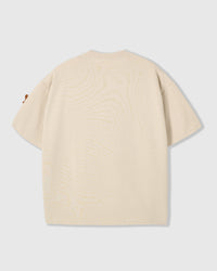 Back view of STICKYZOO cream Dachshund Parade T-Shirt showing boxy silhouette and dachshund peeking at sleeve