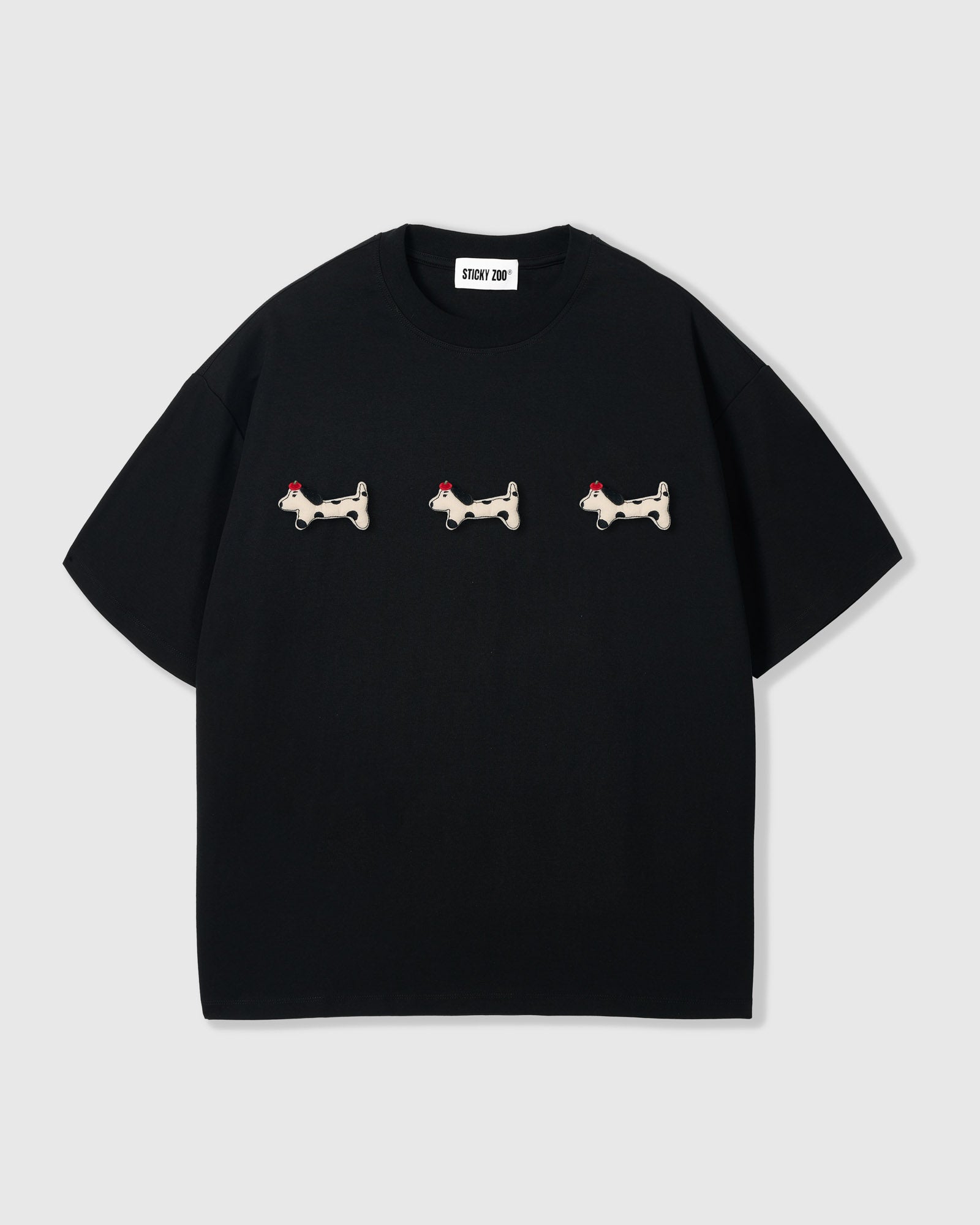 {{Three spotted dachshunds}} STICKYZOO Spotty Dash Trio T-Shirt in black — three hand-stitched plush spotted dachshund appliqués with red berets on 230gsm cool-touch cotton