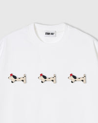 Three plush spotted dachshund appliqués with red beret detail on STICKYZOO white oversized t-shirt