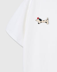 Single plush spotted dachshund appliqué with red beret — hand-stitched on white 230gsm cotton