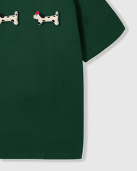 Spotted dachshund plush appliqué detail showing hand-stitched craft on STICKYZOO green t-shirt