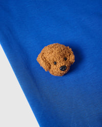 Model styling blue Poodle Parade T-Shirt with seven hand-stitched plush poodles