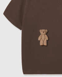Detail of standing teddy bear applique on dark brown STICKYZOO t-shirt showing dimensional hand-stitched texture
