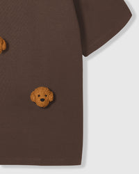 Detail of lower body area on brown Poodle Parade T-Shirt showing plush poodle appliques