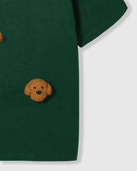 Detail of lower body area on green Poodle Parade T-Shirt showing plush poodle appliques