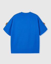 Detail of lower body area on blue Poodle Parade T-Shirt showing plush poodle appliques