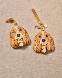 Cocker Spaniel leather bag charm shown in both attachment options — handmade French Alran leather and suede, dual attachment for bags or keys. STICKYZOO Amsterdam design.