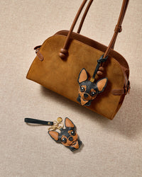 Chihuahua leather bag charm shown in both attachment options — handmade French Alran leather and suede, dual attachment for bags or keys. STICKYZOO Amsterdam design.
