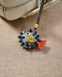Pufferfish charm — every spike stitched into the French Alran goatskin body by hand.