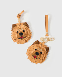 Chow Chow leather bag charm in both attachment formats — leather strap with engraved 18K gold cube and 18K gold-plated keychain clip with engraved gold tag. Handmade French Alran leather and suede.