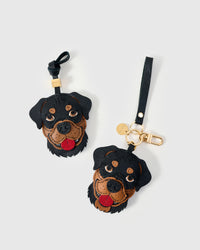 Handmade Rottweiler leather bag charm shown in both attachment formats — hand-cut black and tan French Alran goatskin panels, 18K gold-plated hardware. STICKYZOO collectible.