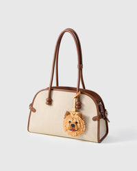 Handmade Chow Chow leather bag charm on a cream canvas handbag — French Alran goatskin and suede from a tannery founded in 1903 in Tarn, France. STICKYZOO limited collectible.