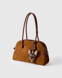 Handmade Chihuahua leather bag charm on a brown suede handbag — French Alran goatskin and suede from a tannery founded in 1903 in Tarn, France. STICKYZOO collectible.