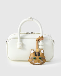 Forest Tabby styled on a cream top-handle box bag, front — real French leather, made to be carried on the bag that sees every day.