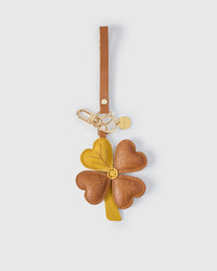 STICKYZOO Lucky Clover Charm — four heart-shaped leaves with hand-stitched vein lines in wine red French Alran goatskin. 3-day handmade piece.