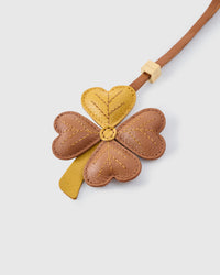 Close-up of STICKYZOO Lucky Clover Charm — full-grain French Alran goatskin from Tarn, France. Four heart-shaped leaves with hand-stitched vein lines. 3-day handmade piece.