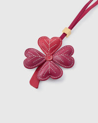 Close-up of STICKYZOO Lucky Clover Charm — full-grain French Alran goatskin from Tarn, France. Four heart-shaped leaves with hand-stitched vein lines. 3-day handmade piece.