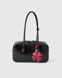 STICKYZOO Lucky Clover Charm — hand-cut, hand-stitched four heart-shaped leaves with hand-stitched vein lines in French Alran goatskin. Designed in Amsterdam.