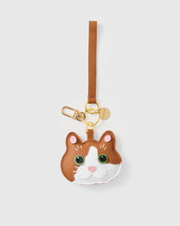 Patchwork cat on an 18K gold-plated keychain clip with engraved STICKYZOO disc — clips to keys, bags or backpacks.