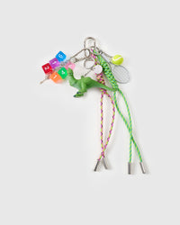 Curated charm stack | STICKYZOO Dino Stack Charm flat lay featuring green resin dinosaur, translucent rainbow numbered dice, mini silver tennis racket with felt ball, and green and pink hand-braided paracord ropes with stainless steel metal tips