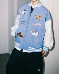 Close-up of chenille puppy patch and embroidered dog characters on light blue varsity jacket body