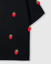 Detail of plush strawberry appliques near hem on STICKYZOO Strawberry T-Shirt in black