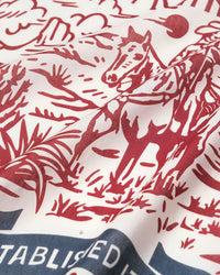Hand-illustrated cowboy on horseback printed in burgundy archival ink on the STICKYZOO western ranch silk scarf
```