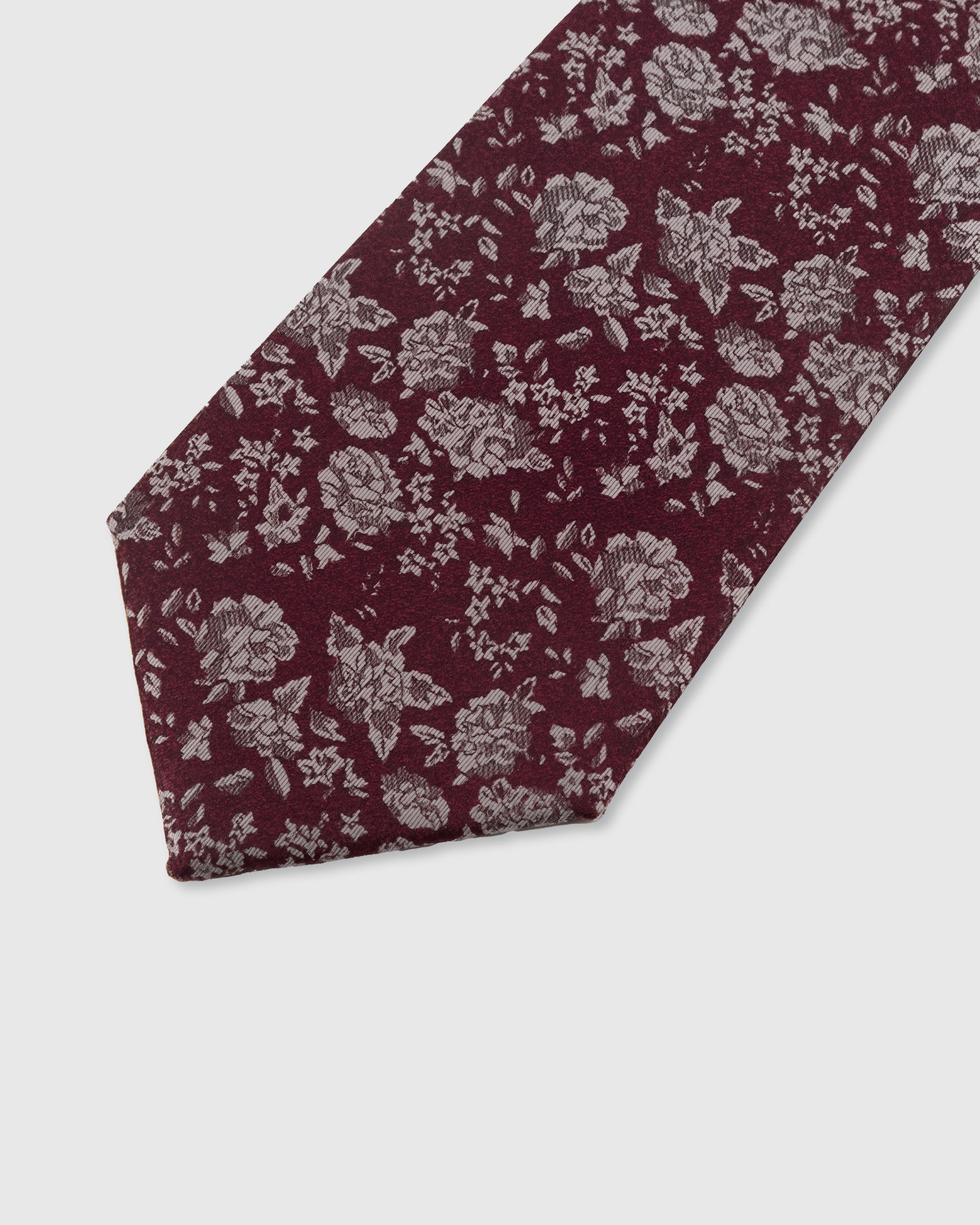 STICKYZOO WINE DITSY TIE — hand-embroidered detail showing silver-tone scattered ditsy floral and leaf motifs, stitched not printed
