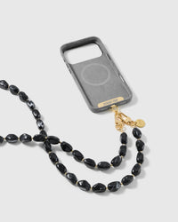 Full phone worn on the long black beaded cross-body strap in a studio setting