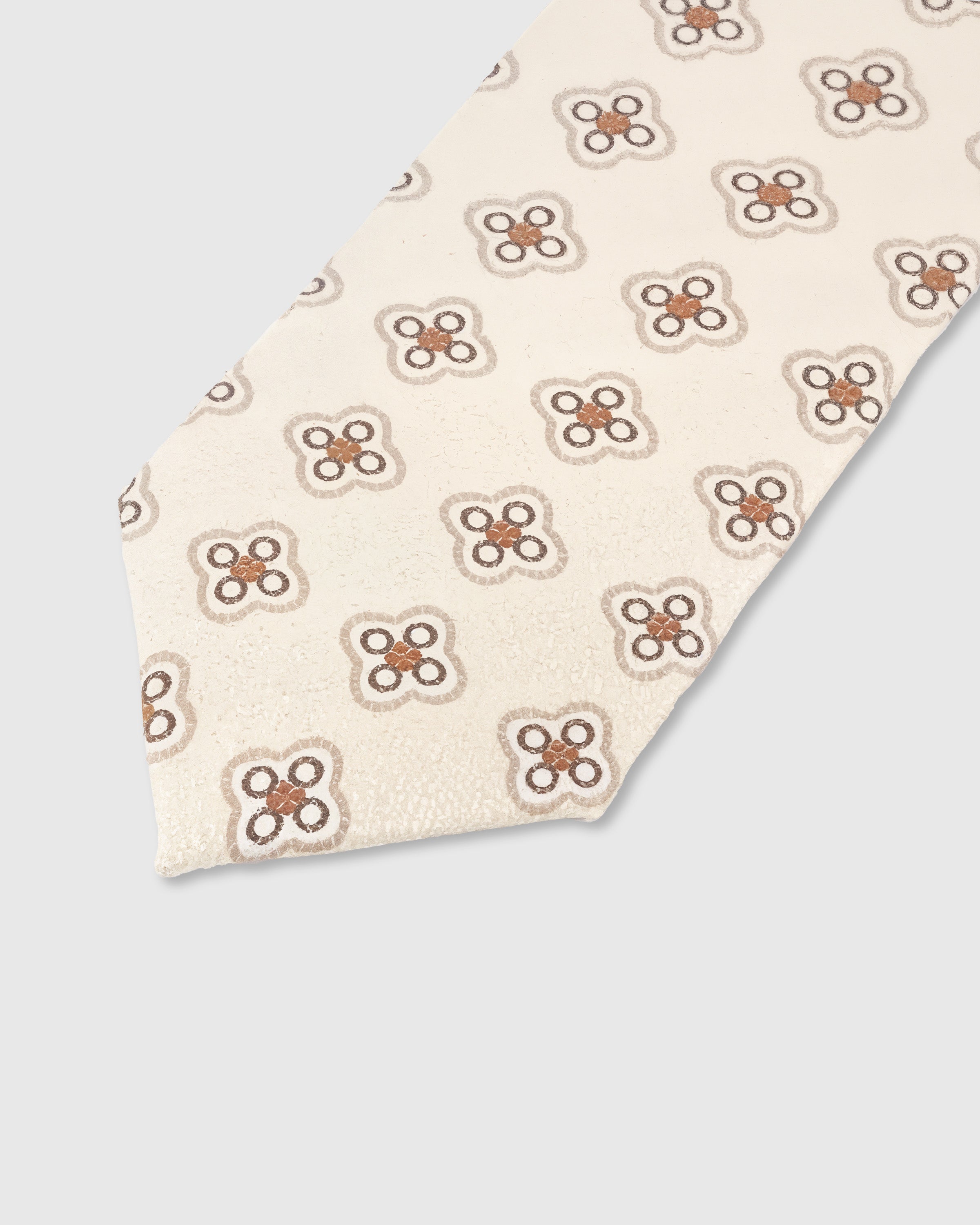 Sienna quatrefoil medallion detail on ivory mulberry silk tie showing raised hand-embroidered motif by STICKYZOO