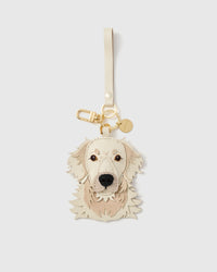 cream golden retriever charm with 18K gold-plated keychain clasp and engraved STICKYZOO coin. French Alran goatskin + alcantara suede.