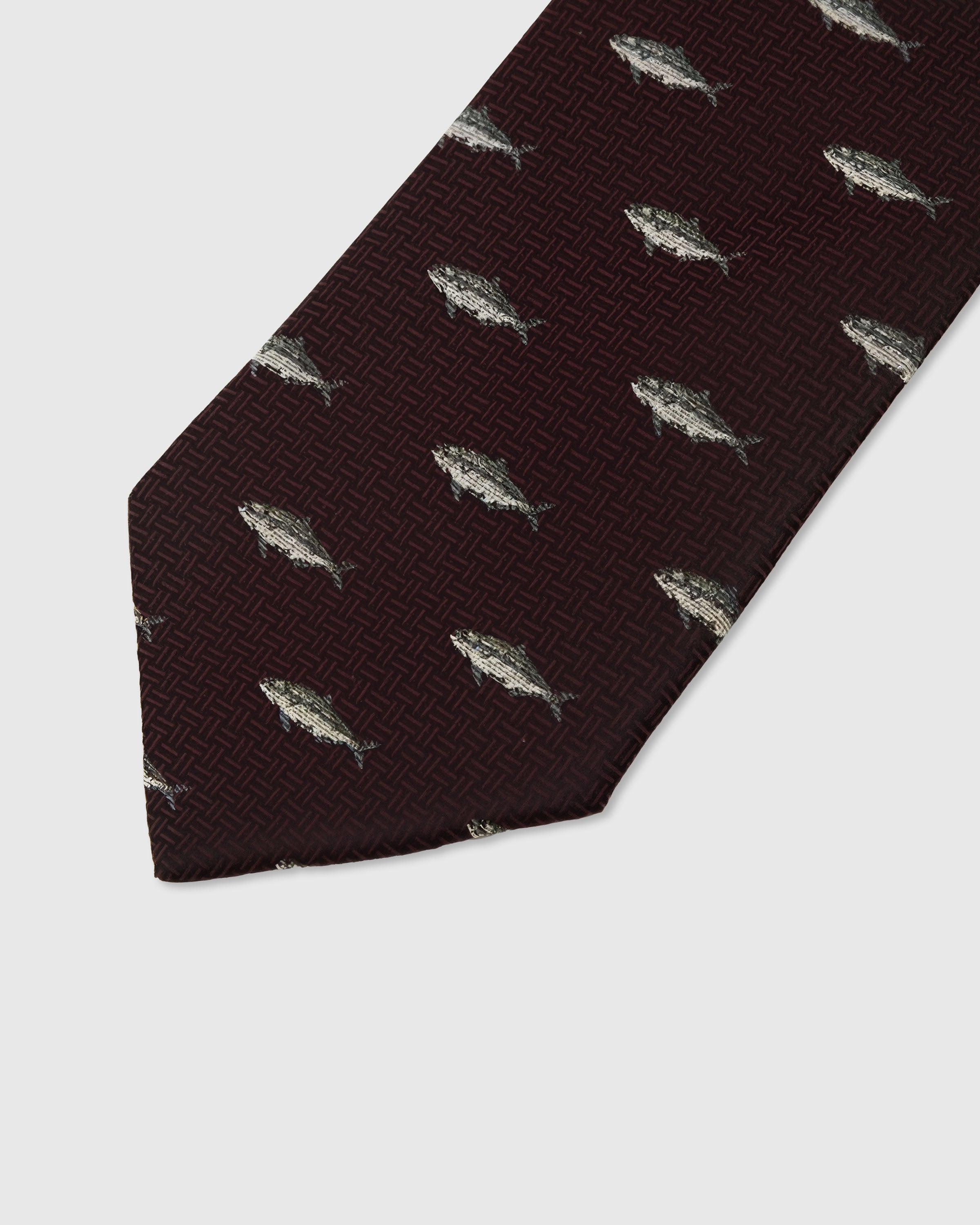 Silver trout motif detail on burgundy mulberry silk tie showing raised hand-embroidered thread by STICKYZOO