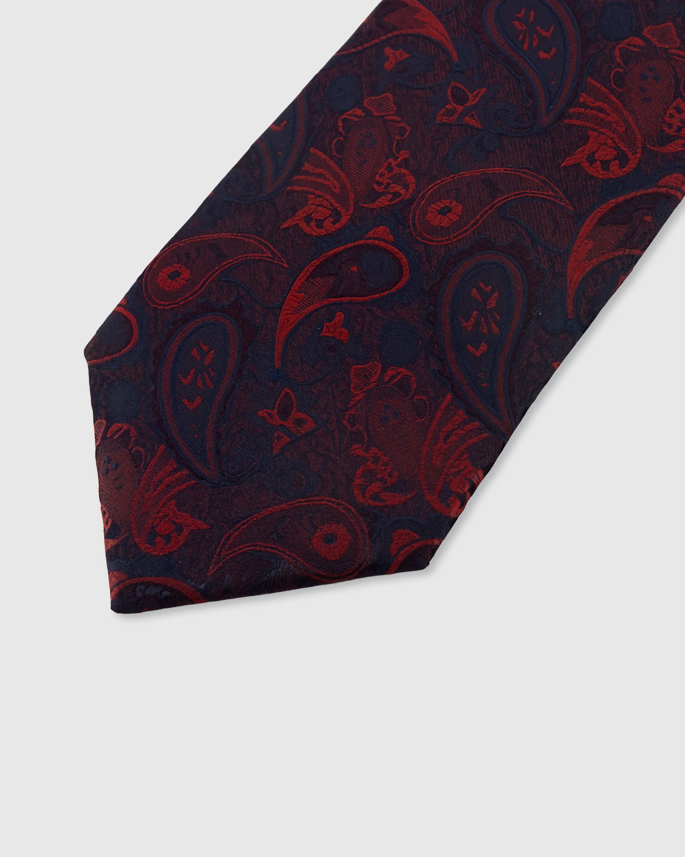 STICKYZOO MIDNIGHT SCARLET PAISLEY TIE — hand-embroidered detail showing scarlet red paisley scrollwork motifs, stitched not printed