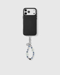Aurora Starfish strap looped from the base of a black phone case, showing iridescent aurora beads, jelly starfish and a glossy black bead