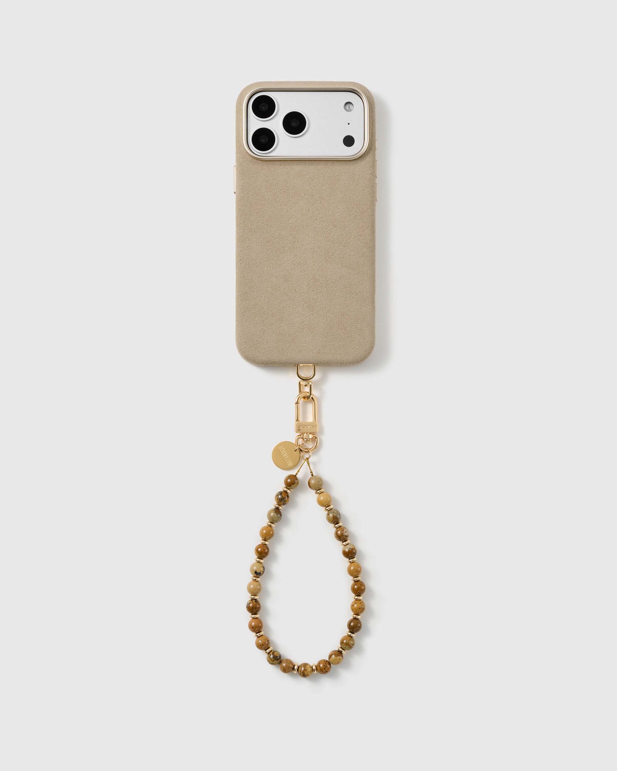 Full phone with the earthy tan and brown stone bead wrist strap attached, studio shot on a plain background.