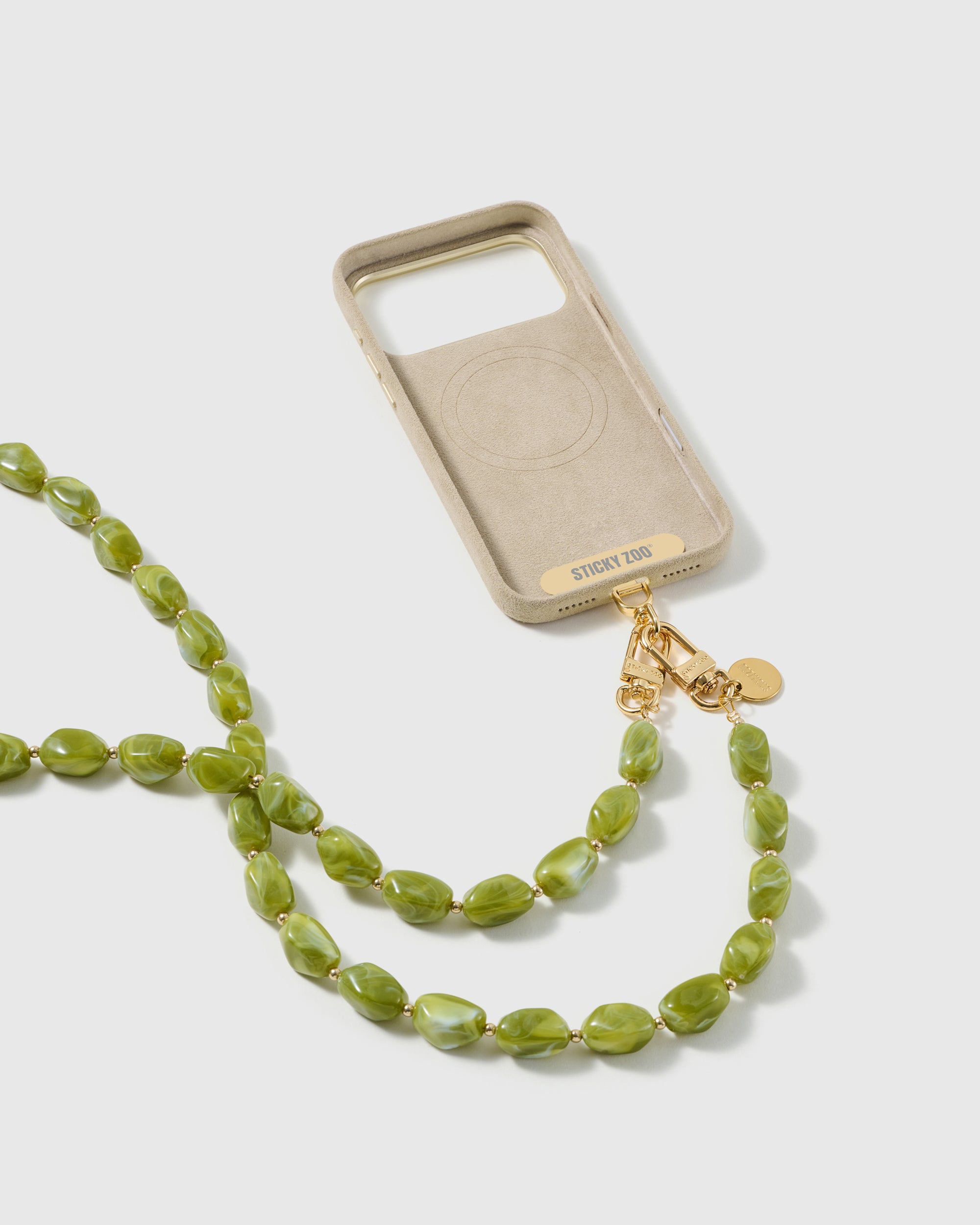 Full phone with the olive resin beaded cross-body strap attached, studio shot showing hands-free everyday carry at hip height