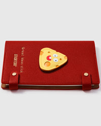 Cheeze Pop layered leather charm detail showing hand-stitched yellow and orange cheese character on STICKYZOO notebook