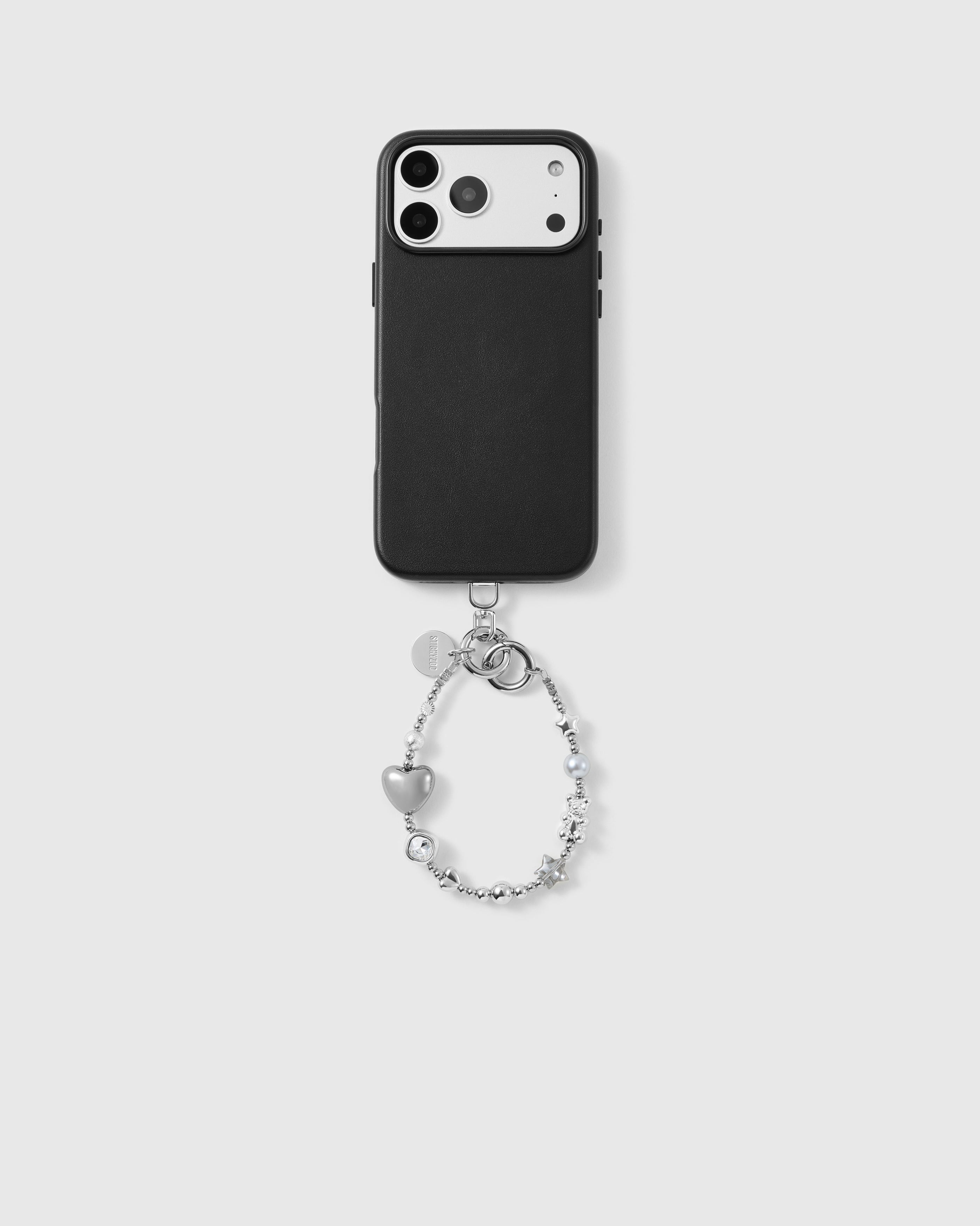 Black phone case shown from the back, camera side up, with the silver heart-and-star beaded wrist strap looped from the base, hardware clasp and beads visible