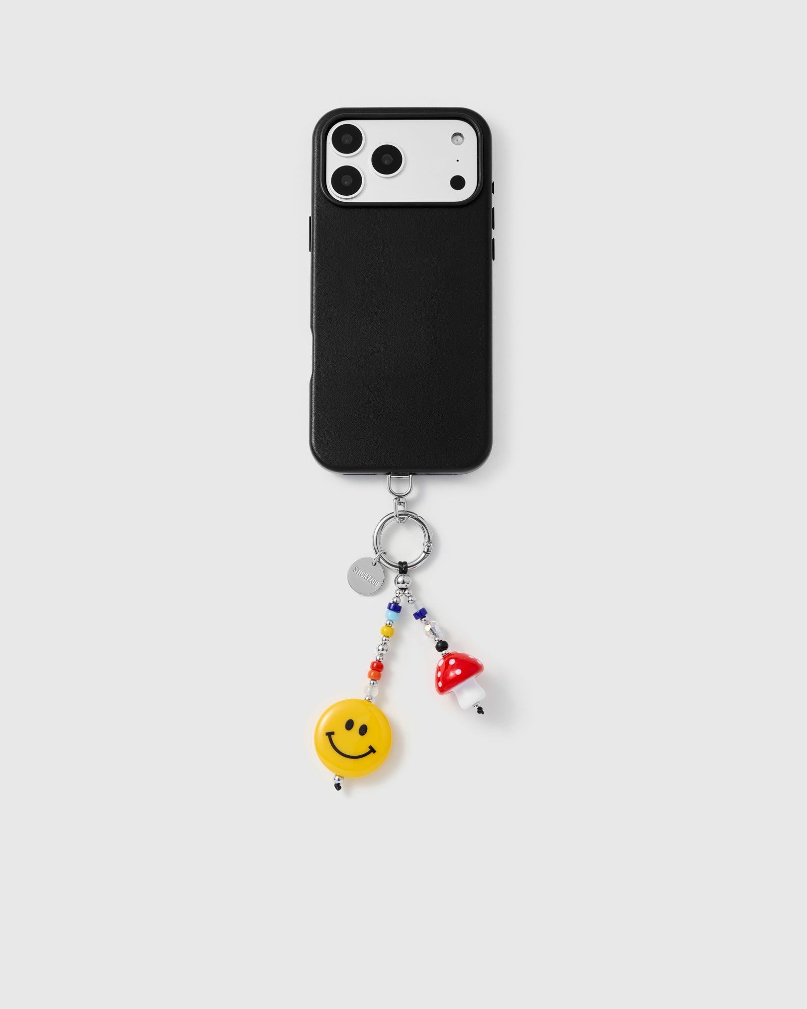 {{Works with any case}} STICKYZOO smiley mushroom phone charm attached to black iPhone case showing everyday carry
