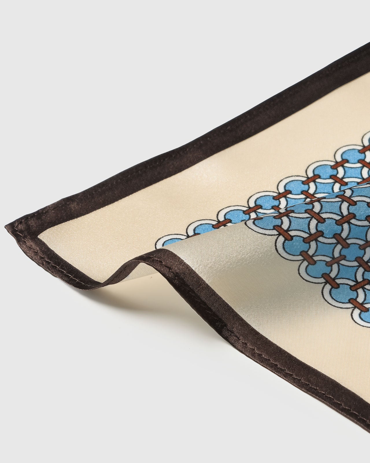 Silk scarf draped to show the cornflower trellis print and the soft espresso border falling open
