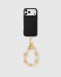 Close-up of glossy apricot cube beads and translucent butter-yellow round beads with gold spacers