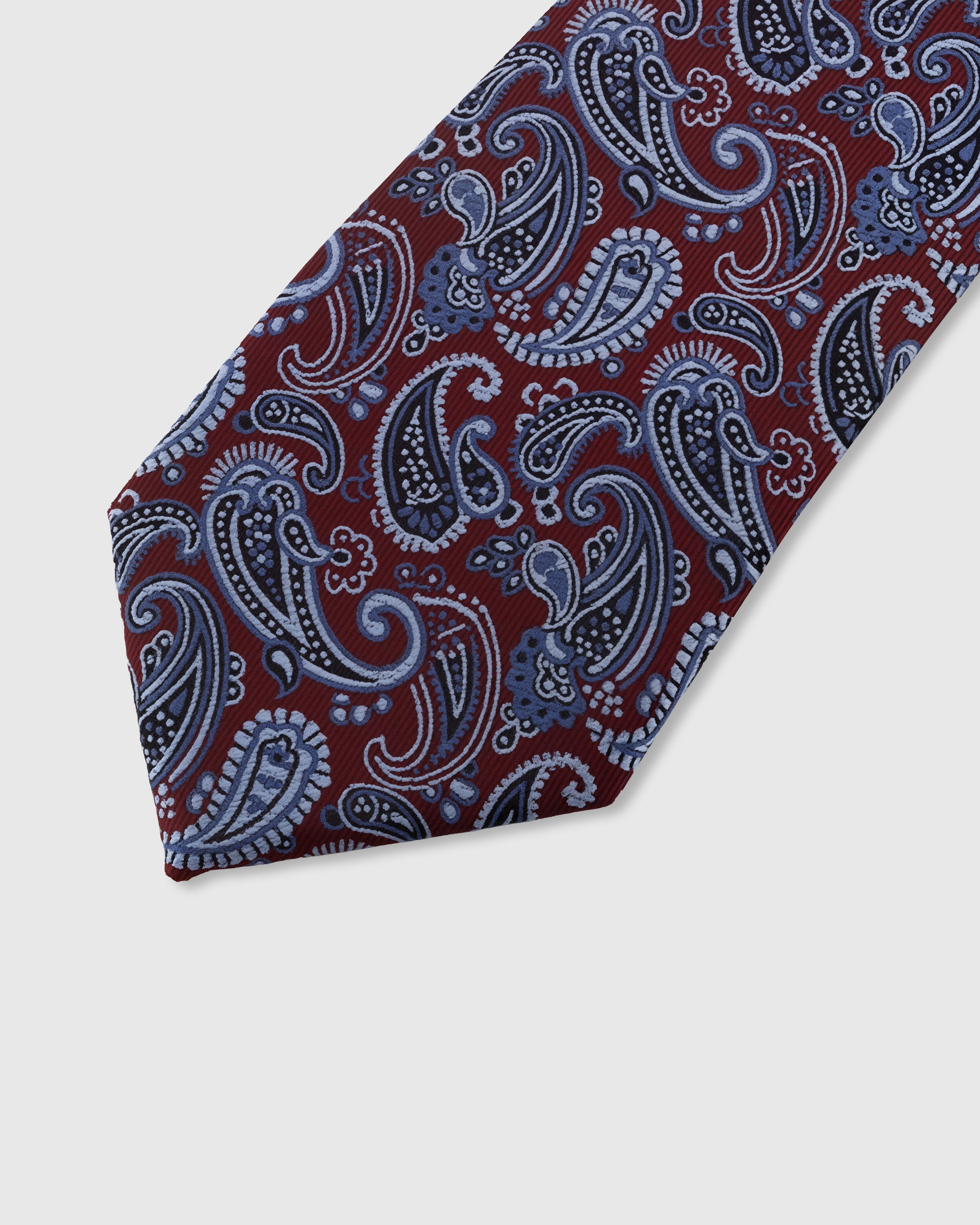 CRIMSON PAISLEY TIE — 45° Italian bias-cut construction with structured interlining, hand-finished slip stitching visible on interior