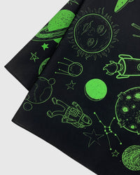 Close-up of the hand-illustrated sun with a face and astronaut printed in archival lime ink on silk