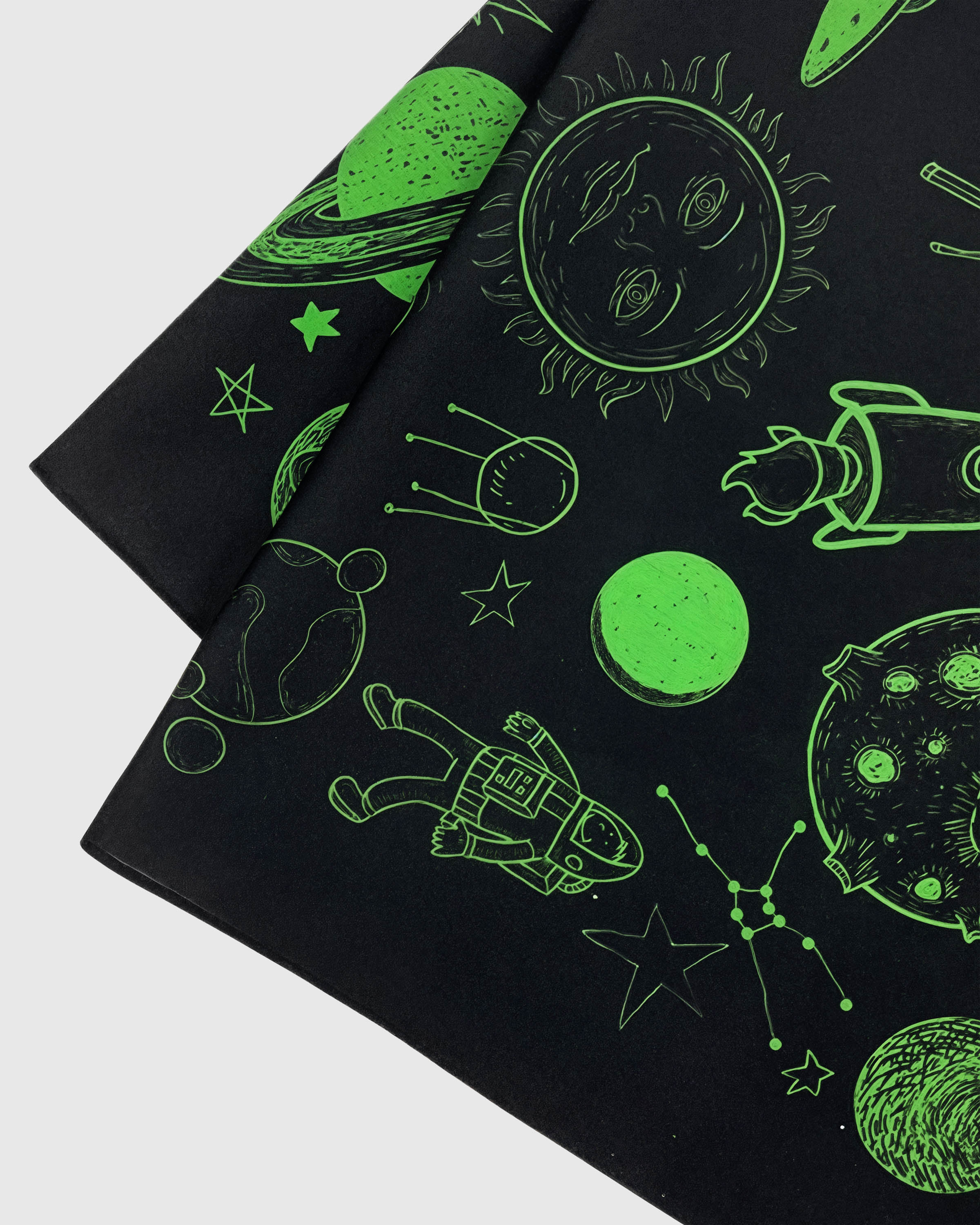 Close-up of the hand-illustrated sun with a face and astronaut printed in archival lime ink on silk