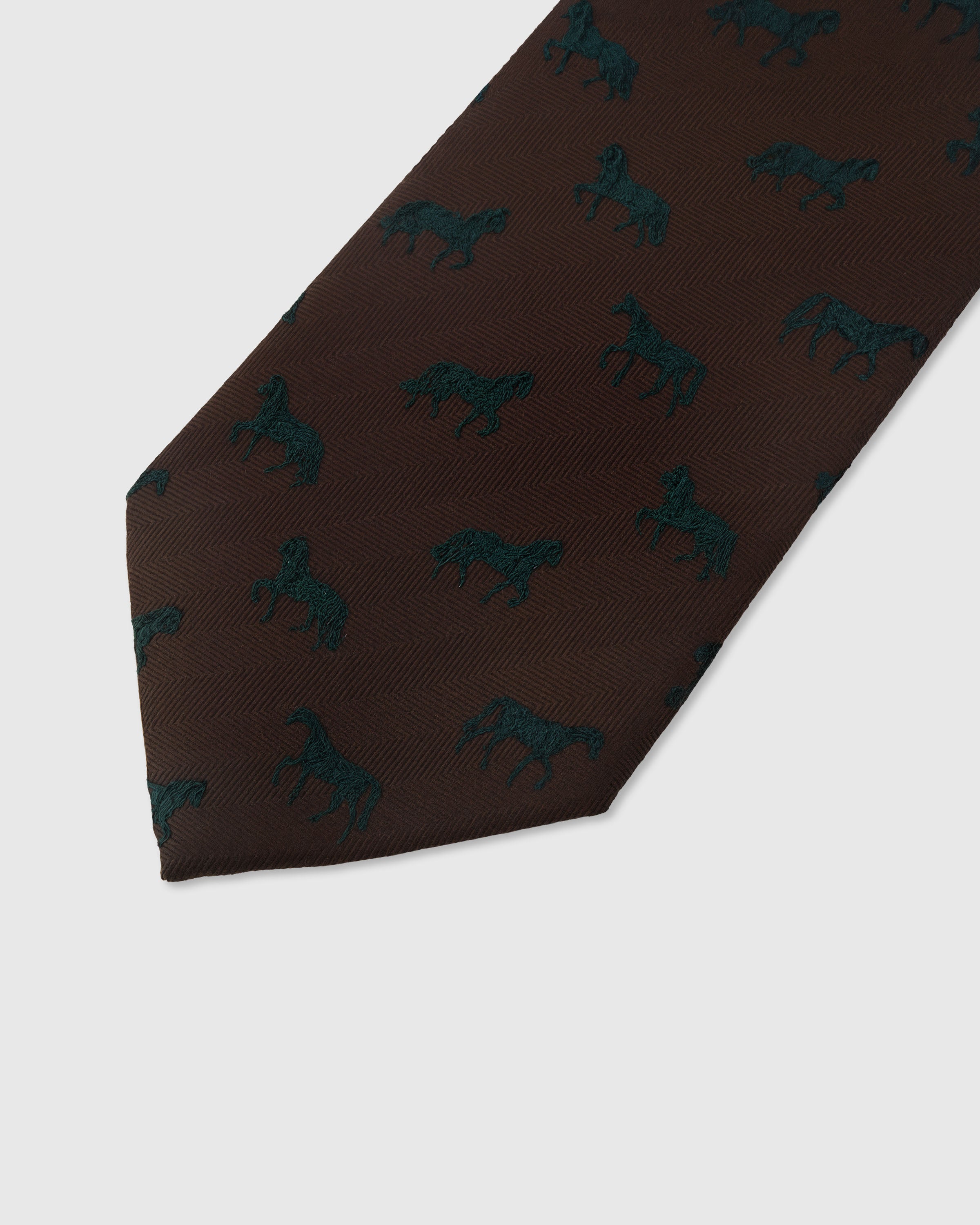 Teal stallion motif detail on cocoa mulberry silk tie showing raised hand-embroidered thread by STICKYZOO